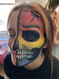 a woman with a colorful face painted with a skull