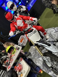 a man in a red ranger costume on a dirt bike