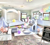 a children's party room with balloons and a bed