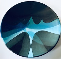 a black and blue plate with a design on it