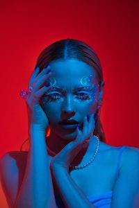 a woman with blue and red makeup on her face