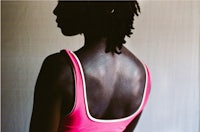 the back of a woman in a pink top