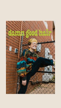 a woman in a colorful sweater is posing in front of a fence with the words dema good hair