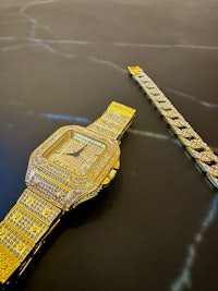 a gold watch and bracelet with diamonds on it