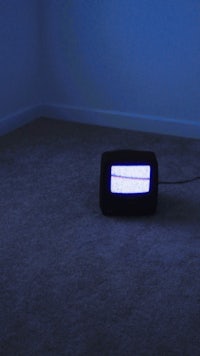 a tv sitting on the floor in a dark room