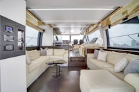 the interior of a boat with a couch and tv