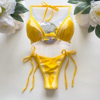 a yellow bikini set with flowers on it
