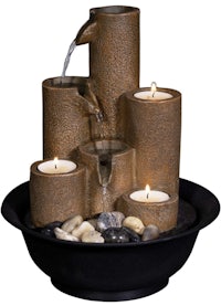 a water fountain with candles in a black bowl