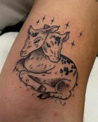 a tattoo of a deer with stars on it