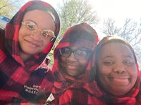 three women in plaid hoodies taking a selfie