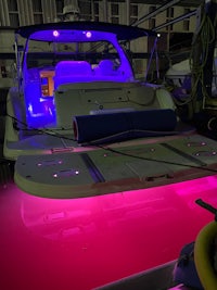 a boat with purple lights on it
