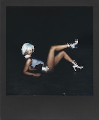 polaroid of a woman laying on the floor