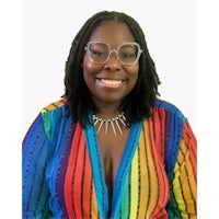 a black woman wearing glasses and a rainbow striped shirt