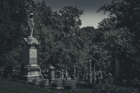 a cemetery with a statue in the middle of it