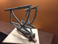 a sculpture of a bicycle frame on top of a table