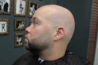 a man with a bald head in a barber shop