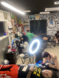 a man sitting in a tattoo shop