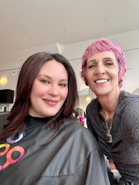 a woman in a hairdresser's chair with a woman in a hairdresser's chair