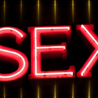 a neon sign that says sex