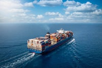 an aerial view of a large container ship in the ocean