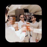a group of men toasting with glasses of beer