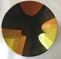 a bowl with a yellow, orange and black design