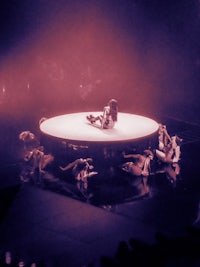 a group of people laying on a circular platform
