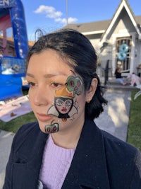 a woman with a face paint on her face