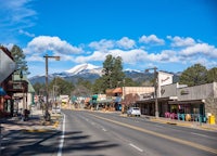 a street in a small town with mountains in the background