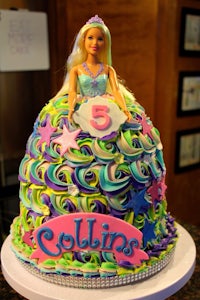 a cake with a barbie doll on it