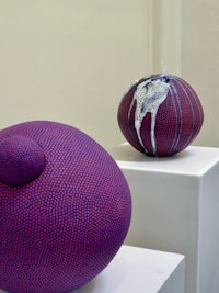 two vases are sitting on pedestals in a room