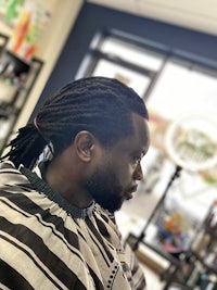 a man with dreadlocks in a barber shop