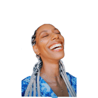 a woman laughing with braids on her head
