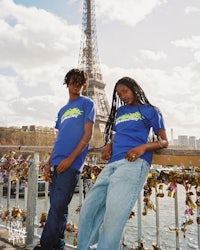 two young men posing in front of the eiffel tower