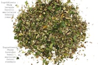 a pile of dried herbs on a white background