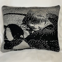 a black and white pillow with a picture of a boy on it