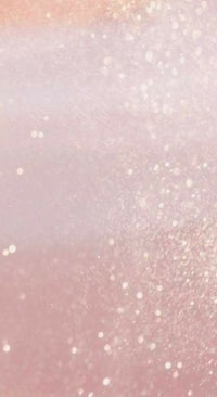 a close up of a pink and gold glitter background