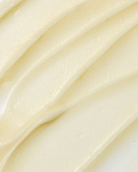 a close up of whipped cream on a white surface