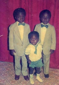three boys in suits posing for a picture