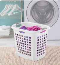 a laundry basket in front of a washing machine