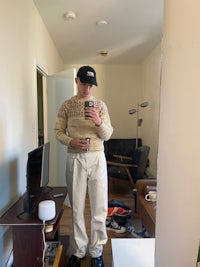 a person standing in front of a mirror taking a selfie