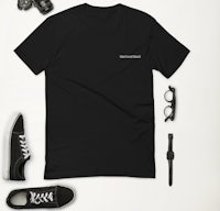 a black t - shirt with a pair of sunglasses and a pair of shoes