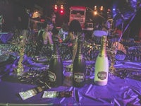 two bottles of champagne on a table at a party
