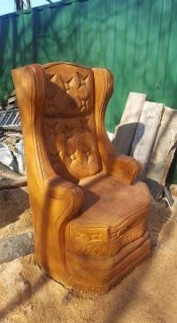 a wooden chair that has been carved out of wood