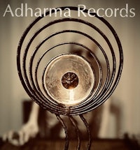 a candle on a table with the words adharma records