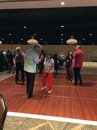 a group of people dancing on a dance floor