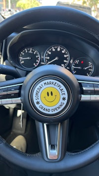 the steering wheel of a car with a smiley face on it