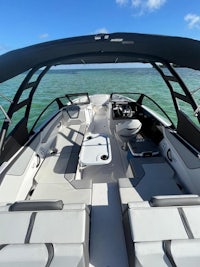 the back of a boat with two seats and a steering wheel