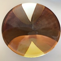 a plate with a brown and white design on it