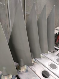 a row of metal blades in a machine shop